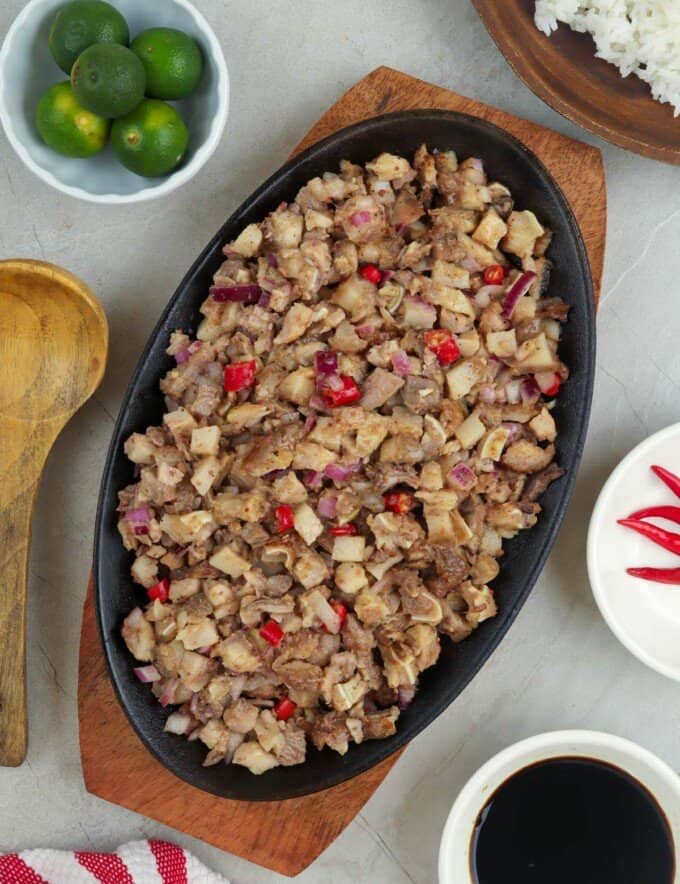 pork sisig on a cast-iron sizzling plate.